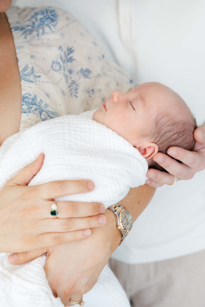 Detail of newborn baby swaddled in soft blanket during a Fort Collins lifestyle session