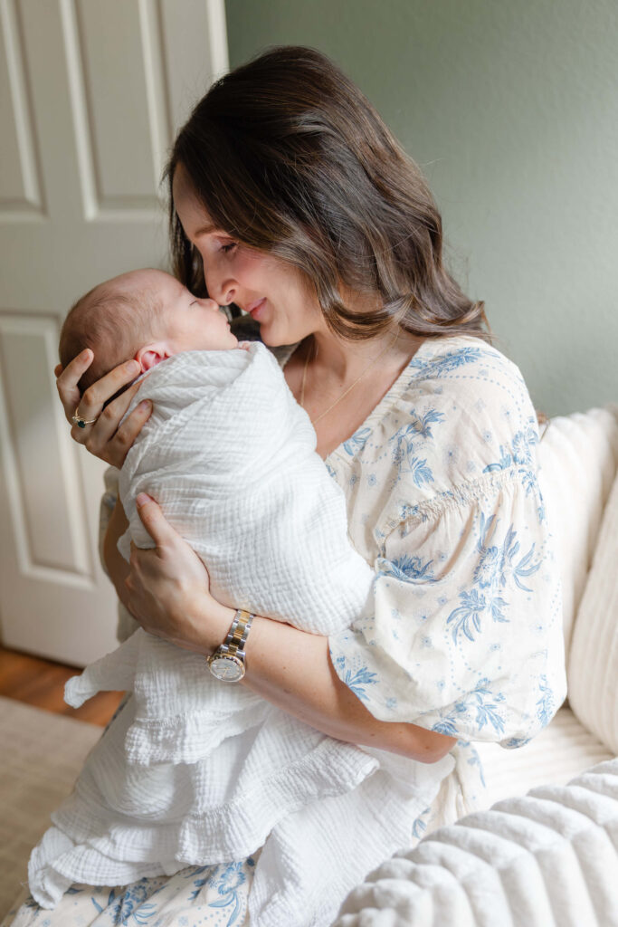 Mom nose to nose with her newborn baby in the nursery during a Northern Colorado session